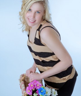 Young blonde woman with flower basket
