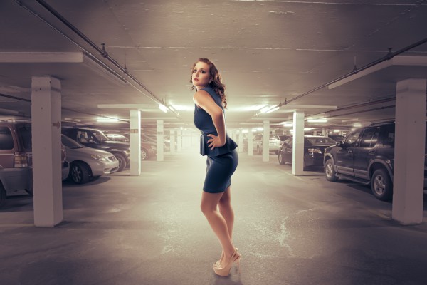 Woman poses in parking garage