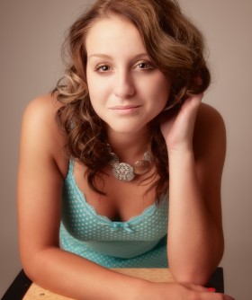Young woman leans toward camera