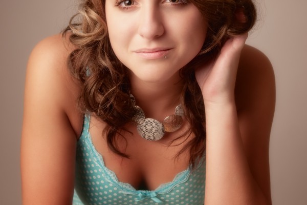 Young woman leans toward camera